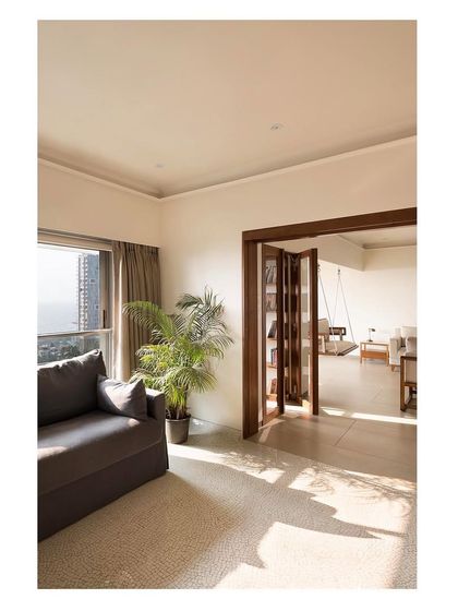 A view from the guest bedroom into the main living area, showing how the open partition creates a seamless flow between spaces, making the entire apartment feel larger.
