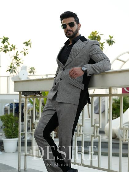 This grey and black suit is a testament to individuality. The color-blocking is designed to flatter the masculine form while making a bold style statement.