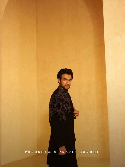 Another angle of Pratik Gandhi, showcasing the intricate embroidery on the back and shoulders of this powerful black jacket.