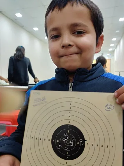 Hitesh, another one of our young talents, proudly showing his target card after a practice session.