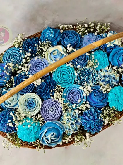 A beautiful and delicious cupcake bouquet in shades of blue. This is a perfect alternative to a traditional cake, offering a stunning visual and individual treats for everyone.