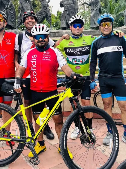 The group posing at the Gyarah Murti sculpture, a common stop on our Delhi rides. We love incorporating history and culture into our routes.
