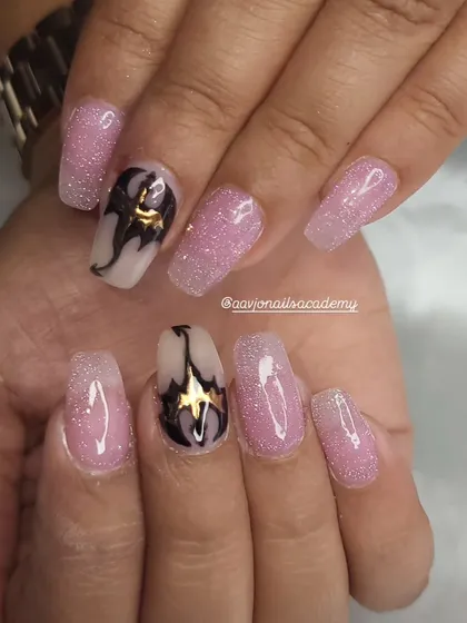 The finished dragon nail art. The combination of the sparkling pink base and the bold, hand-painted dragons makes for a truly unique and personalized set.