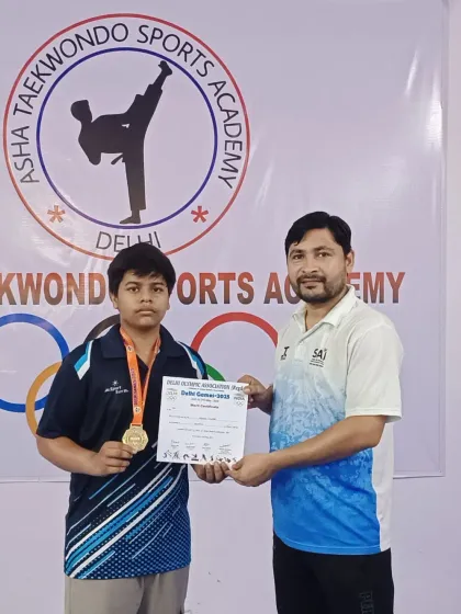 A proud moment for this young champion, holding his gold medal and certificate after a successful run at the Delhi Games.