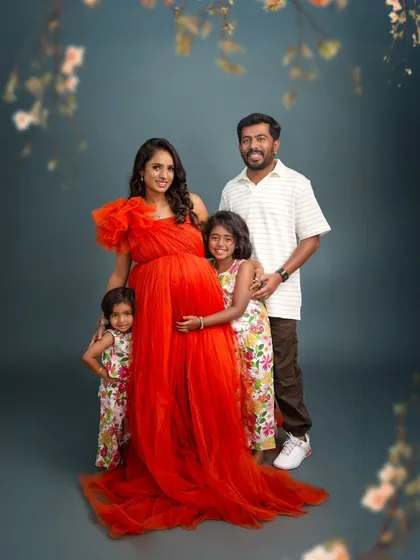 The whole family together. This beautiful portrait shows the parents with their two daughters, all embracing the baby bump, a perfect picture of a family growing with love.