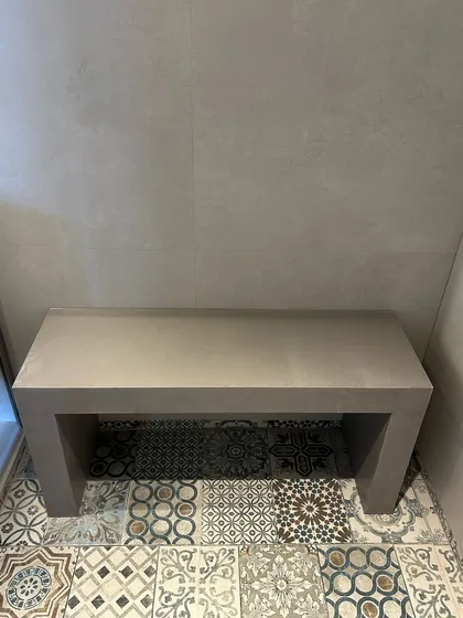 Simplicity can be very powerful. In this shower nook, a clean, minimalist concrete bench sits on a floor of beautiful Moroccan-inspired tiles, creating a functional detail that is also a moment of beauty.
