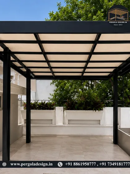 A clean and contemporary design for a spacious terrace. This black powder-coated steel pergola with a light-diffusing roof provides ample shade while maintaining a bright and airy feel, making the space perfect for daytime use.