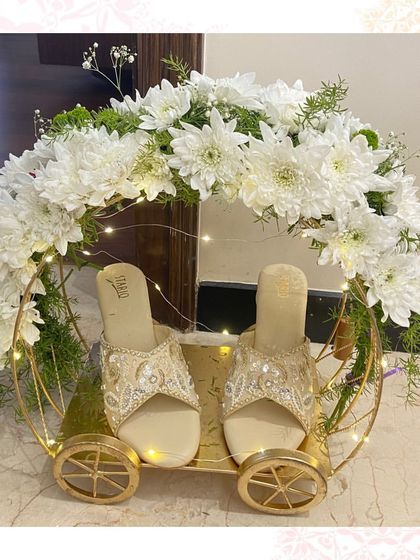 A chariot of elegance for the bride's footwear. We used this beautiful floral carriage display to present a pair of embellished sandals as part of a luxury trousseau.