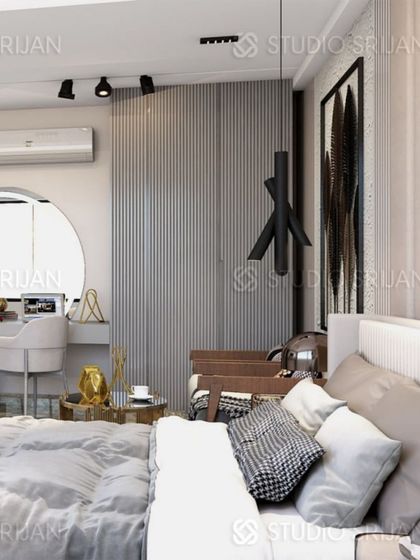 This close-up shows the cozy corner of the bedroom, with a vanity desk set in an arched nook and a modern, sculptural pendant light.