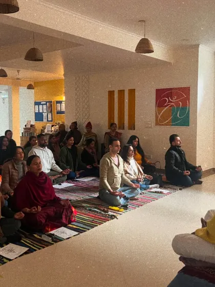 A wide shot of the New Year's satsang, showing the community gathered in shared intention and practice.