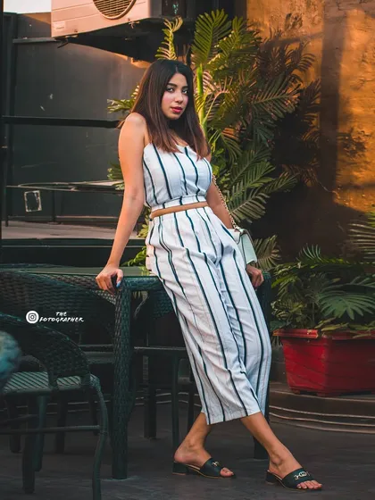 A full-length shot showing the complete outfit in the cafe environment. This is essential for fashion bloggers and influencers.