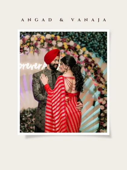 A classic portrait of Vanaja and Angad in front of their floral 'Forever' sign, perfectly summarizing their ring ceremony.