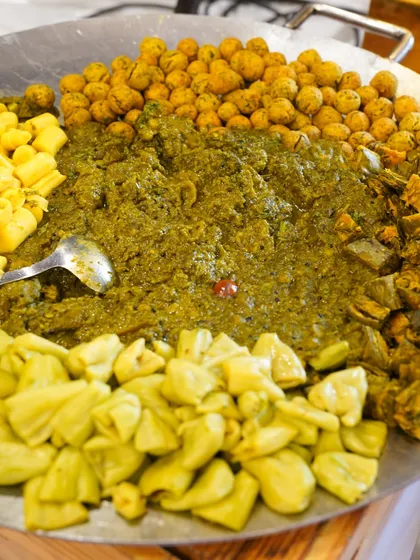 A large platter of Undhiyu, the quintessential Gujarati winter vegetable curry. We prepare it with a mix of traditional vegetables and spices.