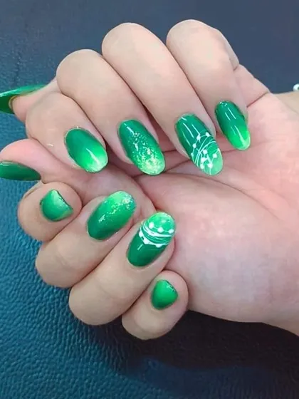 This set showcases a beautiful green ombre effect combined with delicate white line art. Our nail art workshop covers blending, gradients, and precision designs to elevate your skill set.