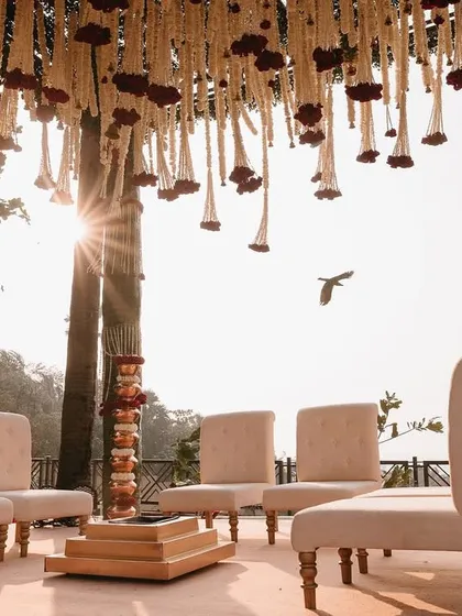 The sun sets behind the mandap, creating a magical golden hour glow for the sunset pheras.