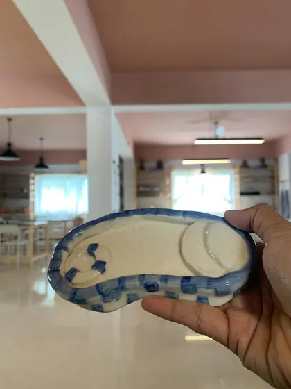 A hand-painted trinket dish in the shape of a swimming pool. Such a playful and creative idea from one of our students.