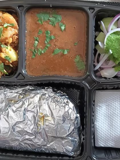 A delicious thali featuring rich dal makhni and homestyle aloo gobhi. This is a classic Punjabi combination that is loved by many of my customers.