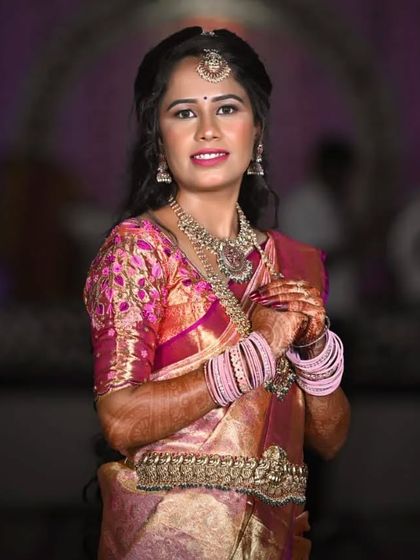 My beautiful client looking radiant in a pink and gold silk saree. This is a perfect example of a classic guest makeover for a wedding or traditional event.
