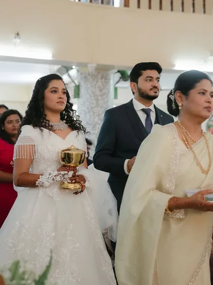 A moment of prayer. The makeup is respectful and understated, perfect for the sanctity of the church ceremony.