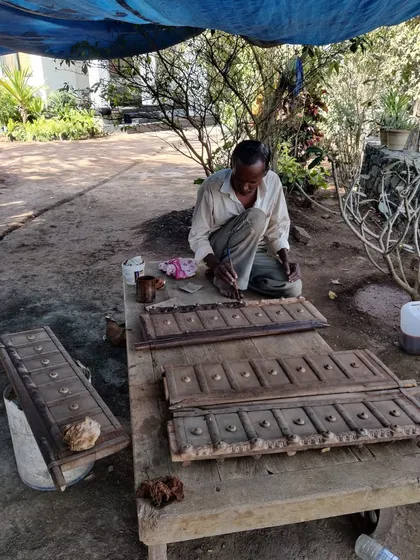 The soul of heritage restoration lies in the details. Here, a skilled craftsman carefully works on restoring an original wooden door, polishing and preserving the intricate details that give the structure its unique character and story.