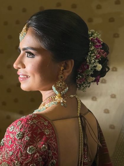 A side profile of the floral updo, showing how the flowers are carefully placed to create a balanced and elegant look.