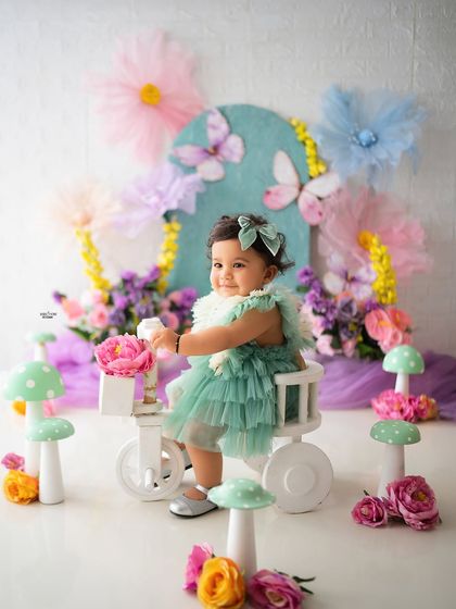Off she goes on her little tricycle, with a basket of flowers in tow. A perfect action shot from her garden-themed shoot.