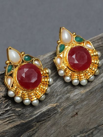 These beautiful studs feature a large red stone surrounded by pearls and smaller green stones, all in a gold-plated finish.