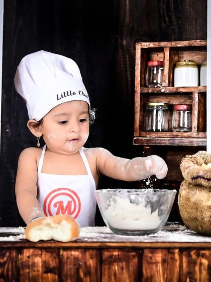 A little chef hard at work, mixing flour in a bowl. These action shots capture the fun of the theme.
