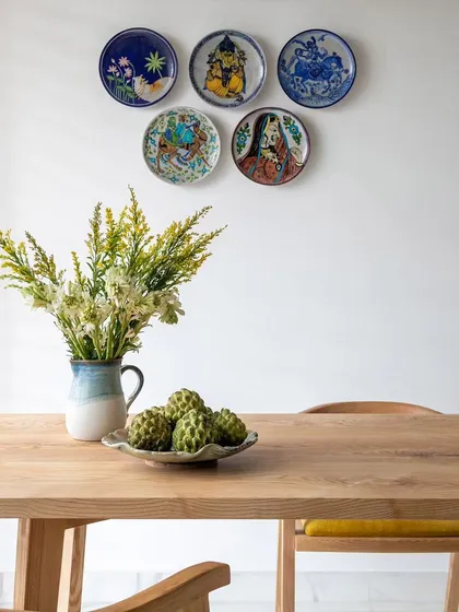 A close-up of the curated wall plates, which serve as a unique focal point in the dining area. This detail shows our commitment to incorporating personal and artistic touches that make a house feel like a home.