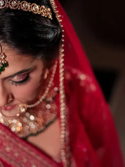 A close-up, top-down shot of the bride, focusing on her intricate maang tikka and beautiful eye makeup at her Jim Corbett wedding.