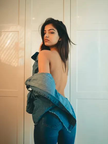 Another shot of the backless denim look, this time with a bit of motion in the hair. It’s a strong and confident pose that really stands out.