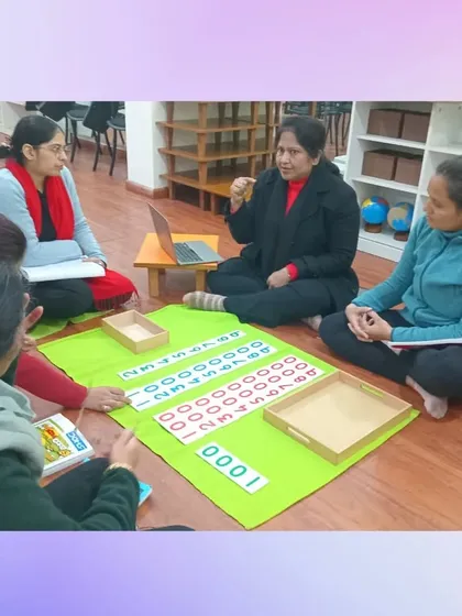 Learning about the decimal system with the golden beads and number cards. Our trainees experience the materials just as a child would, gaining a profound understanding of how these tools make abstract mathematical concepts tangible and clear.