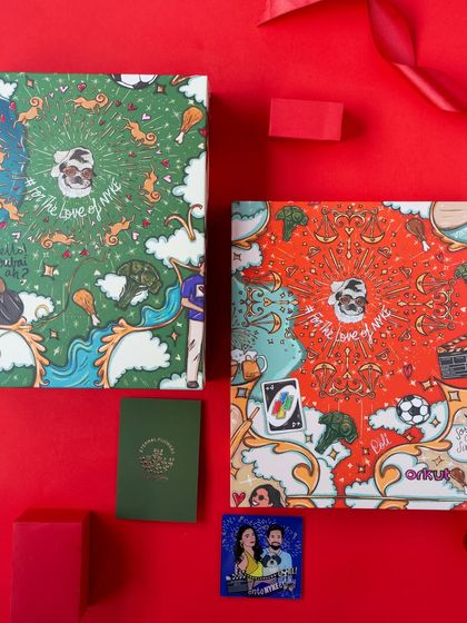 Two versions of the custom doodle art boxes, one in red and one in green, showing how I can adapt a design to create variety for a large event.