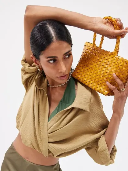 The Axel Mini in a sunny yellow, a perfect blend of craftsmanship and style. Our handwoven bags are designed to be unique, just like the person carrying them.