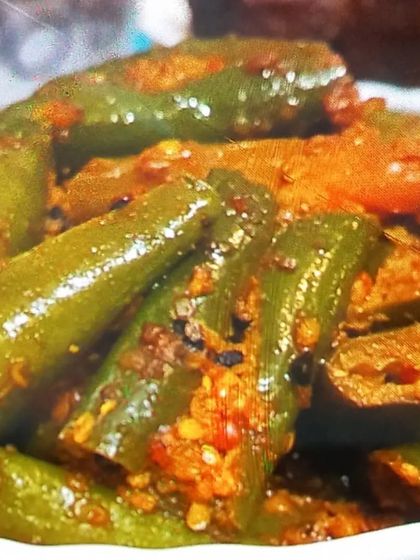 A close-up view of my spicy green chilli pickle. You can see the texture of the roasted spices clinging to the chillies.