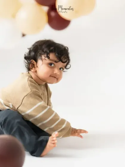 A candid glance back at the camera. I let babies explore the space, which allows for natural and authentic milestone portraits.