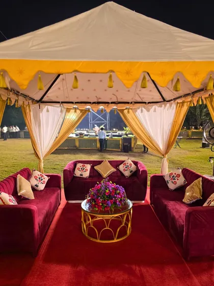 A full view of the royal cabana setup, with its elegant drapery and plush interiors, providing a luxurious and comfortable seating option for guests.