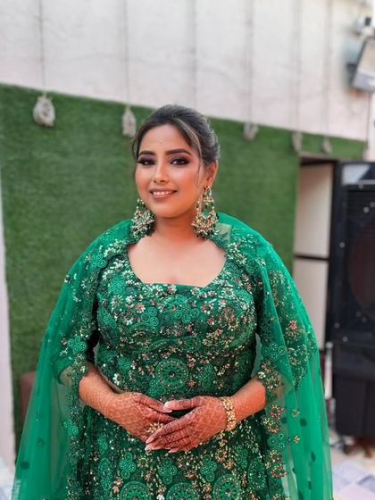 A happy bride ready for her Sangeet. Her emerald green lehenga is a bold choice, which I complemented with a soft smokey eye and a glowing complexion.