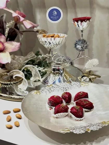 A complete festive serving set. The Maple Noor stand for dry fruits and the Roselle 'thal' for sweets create a coordinated and luxurious look for your Diwali celebrations.