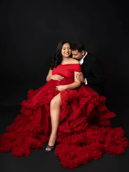 This is what dreams are made of! I love creating these bold, glamorous portraits for moms-to-be. This stunning red gown is part of my client closet, and we used a simple black backdrop in the studio to make the color and the beautiful baby bump truly pop.
