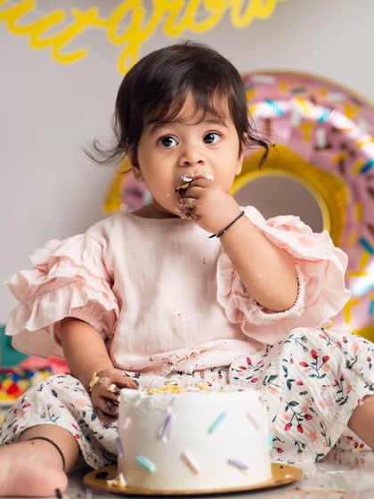 Getting a first taste of birthday cake is a serious business. We love capturing these curious, frosting-filled expressions during our donut-themed cake smash sessions.