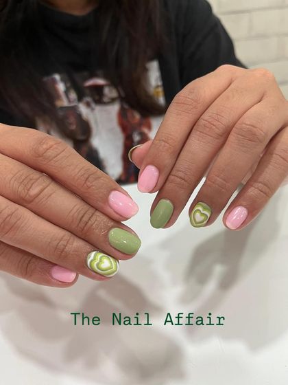 A trendy and cute design combining pastel pink and sage green nails with hand-painted latte art hearts.