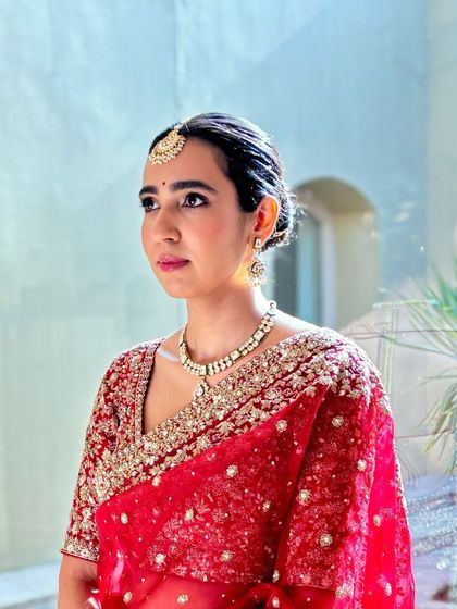 A portrait of Khushboo, looking serene and beautiful. The makeup is minimal, with a focus on clean skin and defined features.