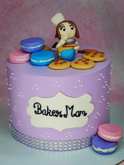 A cake for a "Baker Mom" who is also a pastry chef. This fresh pineapple cake is decorated with fondant macarons and a cute baker figurine.