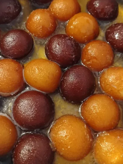 Our gulab jamuns soaking in fragrant, sweet syrup. We make them from scratch with a khoya base, ensuring they are incredibly soft and melt in your mouth. This is comfort food at its best.