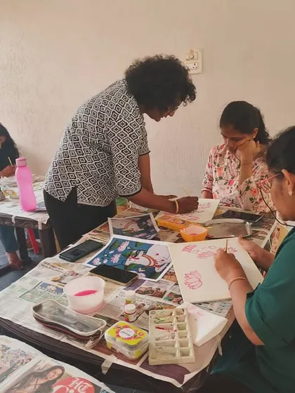 One of our instructors providing individual guidance during a Pichwai painting session. We offer hands on support to every student, ensuring they feel confident as they learn.