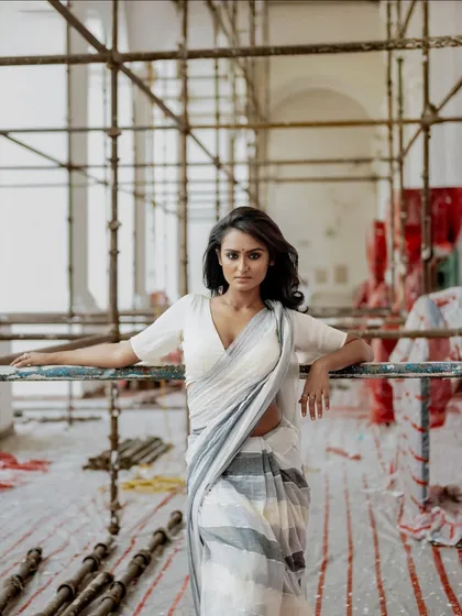 An environmental portrait for AVA India, with the model in a simple white saree against an industrial scaffolding backdrop. This juxtaposition of grace and grit creates a powerful brand statement.