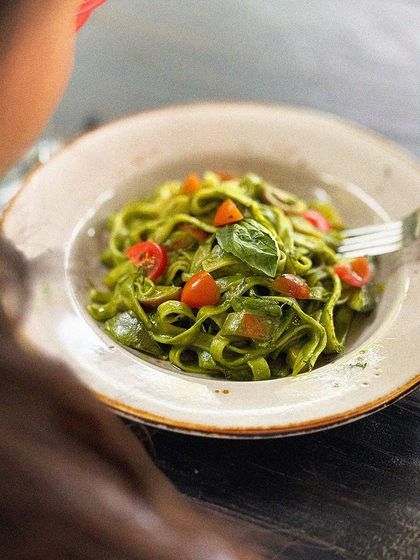 A perfect forkful of our pesto fettuccine, ready to be savored.