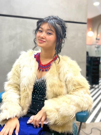 Another shot of this beautiful updo. The style is elegant and intricate, perfect for a special event.