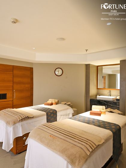 Here is another view of my couples treatment room, showcasing the clean, uncluttered space and professionally prepared massage beds ready to provide a shared, restorative experience.